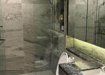 Modern bathroom with marble finishes and glass shower