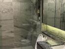 Modern bathroom with marble finishes and glass shower