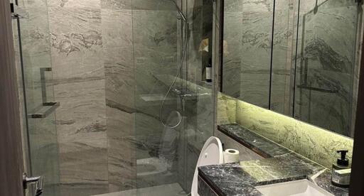 Modern bathroom with marble finishes and glass shower