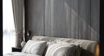 Elegant bedroom with modern grey paneling and plush bedding