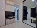 Modern bedroom with mirrored wardrobe and integrated living space