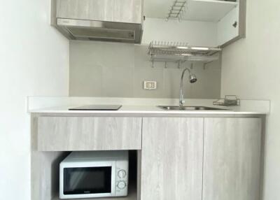 Modern small kitchen with integrated appliances and white cabinetry