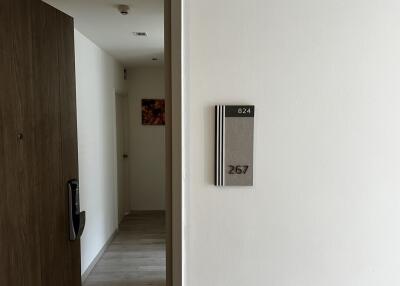 Apartment corridor with door numbers and modern decor
