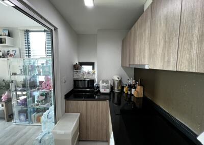 Modern kitchen with wooden cabinets and black countertops