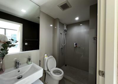 Modern bathroom interior with shower, toilet, and sink