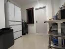 Modern kitchen with white appliances and clean white tiles