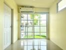 Bright and spacious living room with large glass doors leading to the garden