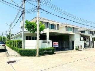 Spacious two-story house for rent with lush greenery and a prominent 