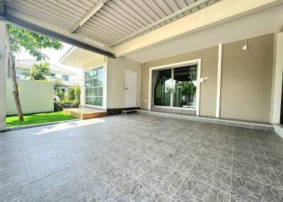 Spacious patio area with gray tiled flooring and modern sliding doors