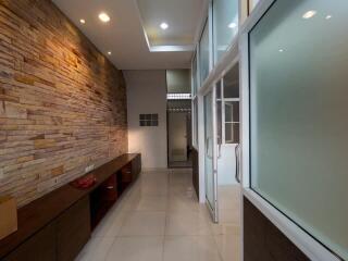 Modern kitchen with stone wall and glass doors