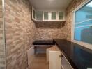 Compact kitchen with stone tile walls and modern countertops