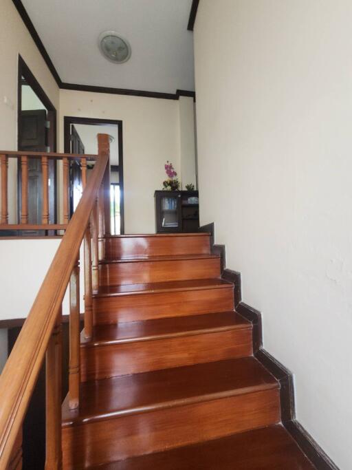 Elegant wooden staircase inside a home leading to the upper floor