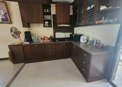 Spacious kitchen with modern wooden cabinets and granite countertops