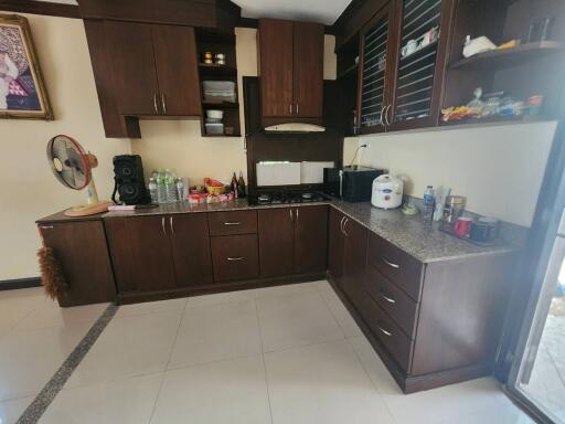 Spacious kitchen with modern wooden cabinets and granite countertops