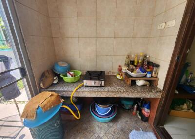 Compact kitchen storage area with various cooking utensils and supplies