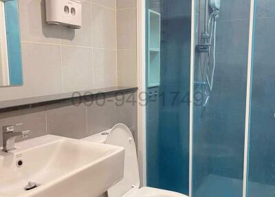 Modern bathroom with shower enclosure and wall-mounted sink