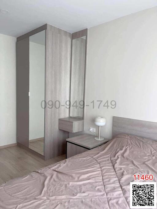 Minimalist style bedroom with large mirror and modern furnishings