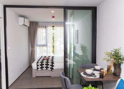 Modern bedroom with sliding glass doors, compact and well-furnished