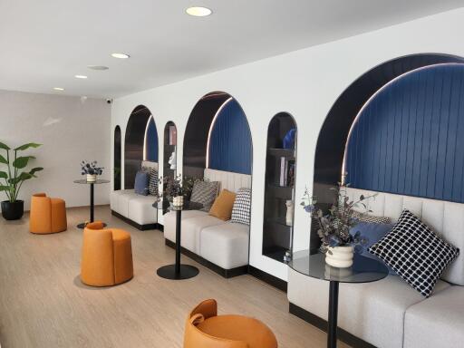 Modern lounge with stylish seating and arched blue alcoves