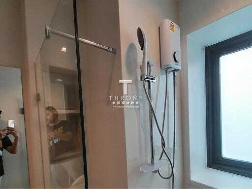 Modern bathroom with glass shower and mounted water heater