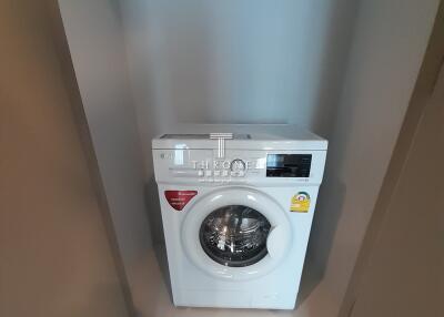 White front-loading washing machine in a modern laundry room