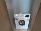 White front-loading washing machine in a modern laundry room