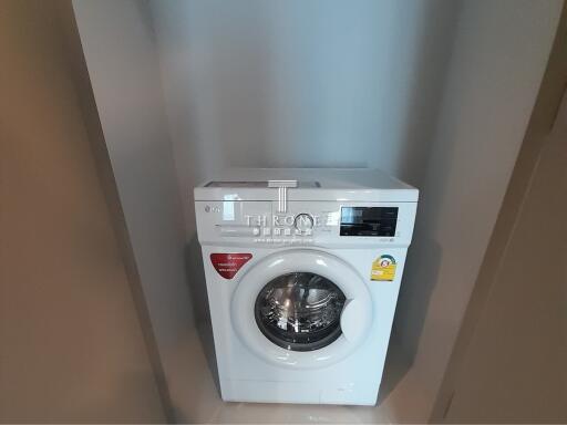 White front-loading washing machine in a modern laundry room