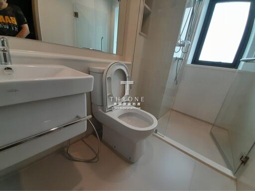 Modern bathroom with white fixtures and a large window