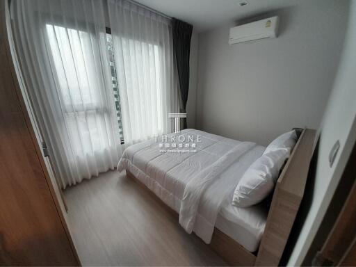 Modern bedroom with large window and air conditioning unit