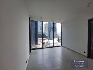 Spacious living room with large windows and city view