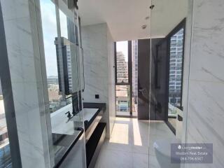 Modern bathroom with large windows and marble finishing