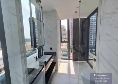 Modern bathroom with large windows and marble finishing