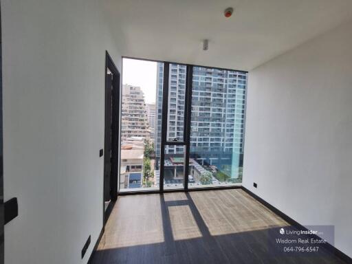 Modern bedroom with large window and city view in a high-rise apartment