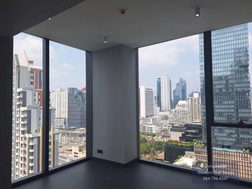 Spacious modern living room with large windows showcasing city skyline views