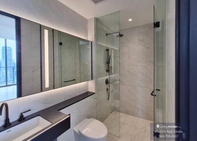 Modern bathroom interior with large mirrors and glass shower