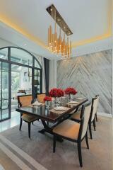 Elegant dining room with modern chandelier and marble walls