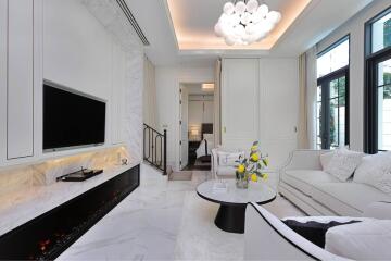 Modern white living room with elegant marble flooring and fireplace