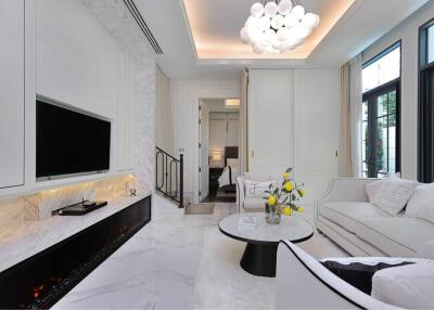 Modern white living room with elegant marble flooring and fireplace