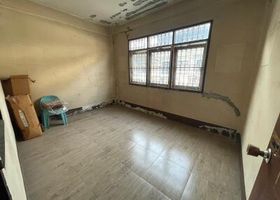 Spacious unfurnished room with tiled flooring and large windows