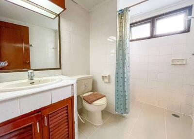 Spacious bathroom with large mirror and window