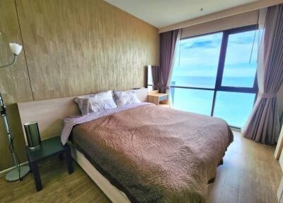 Spacious bedroom with ocean view and wooden decor