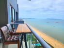 Spacious balcony with a seaside view featuring outdoor seating