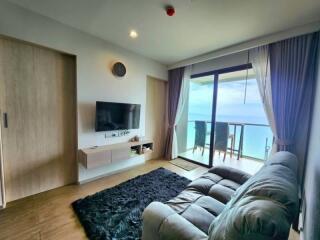Spacious living room with ocean view and modern furnishings