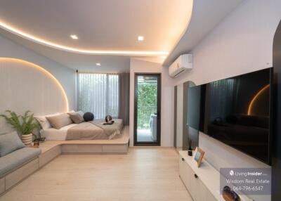 Modern bedroom with integrated living space featuring minimalist design