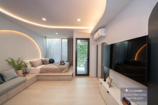 Modern bedroom with integrated living space featuring minimalist design