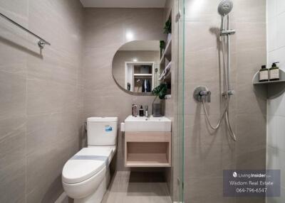 modern bathroom interior with a walk-in shower, mirrored vanity and stylish decor