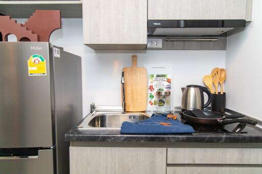 Modern compact kitchen with stainless steel appliances