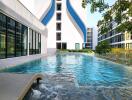 Modern residential building with a luxurious outdoor swimming pool and landscaped areas