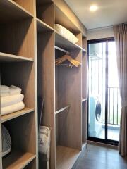 Bedroom with built-in wooden wardrobe and washing machine