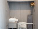 Well-organized storage closet with shelving, ironing board, and clothing items